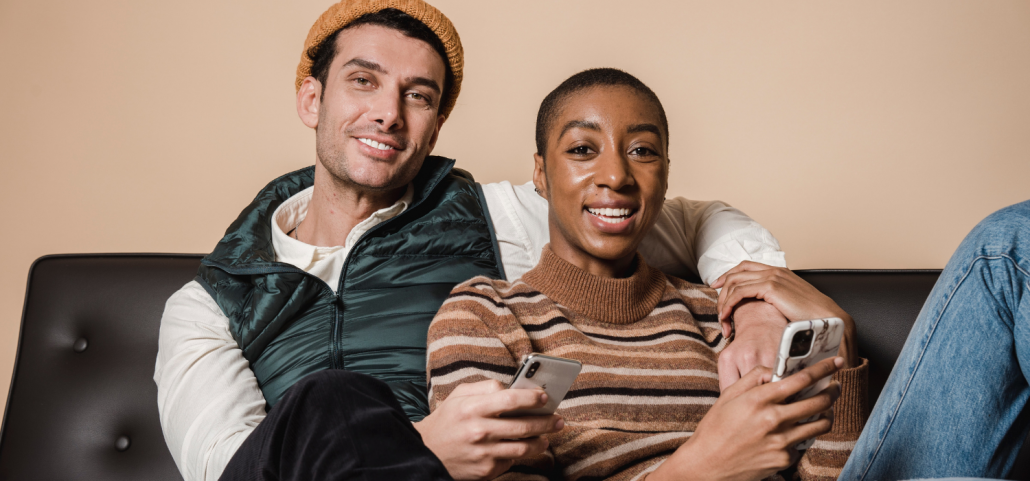 Couple sitting on couch with their phones